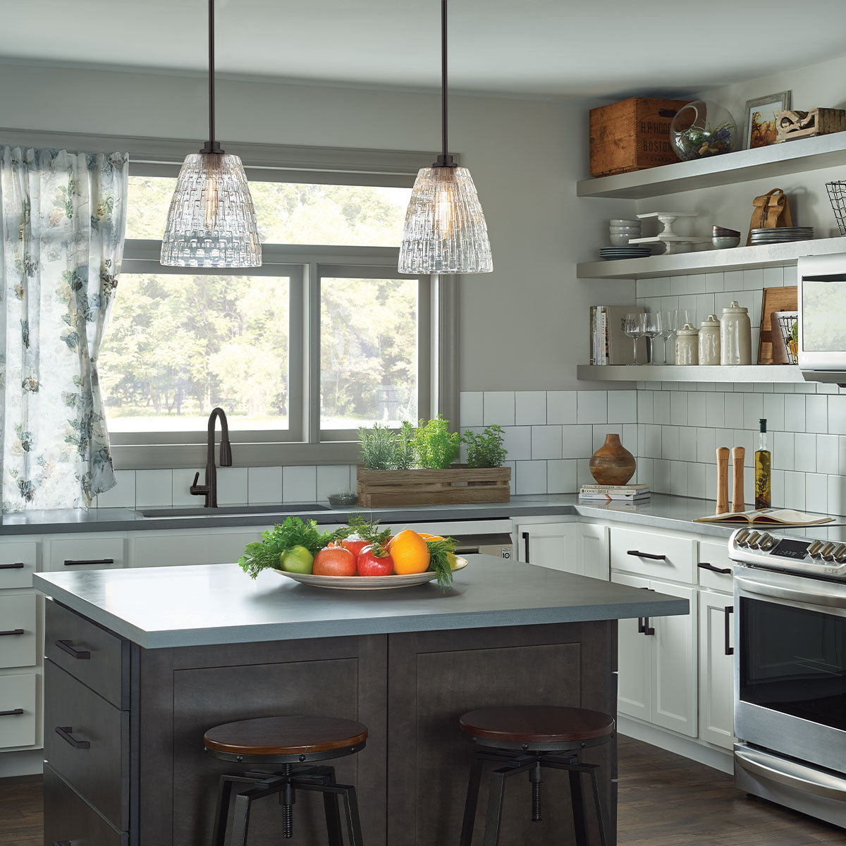 Modern kitchen with island, fruit bowl, and window view