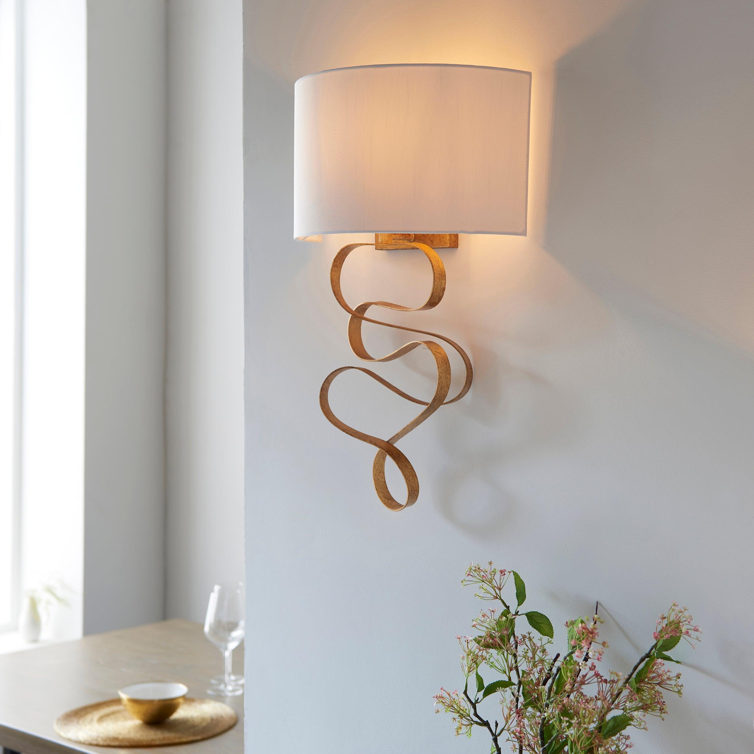 harleston gold modern wall light with ivory shade Close Up Lit Image