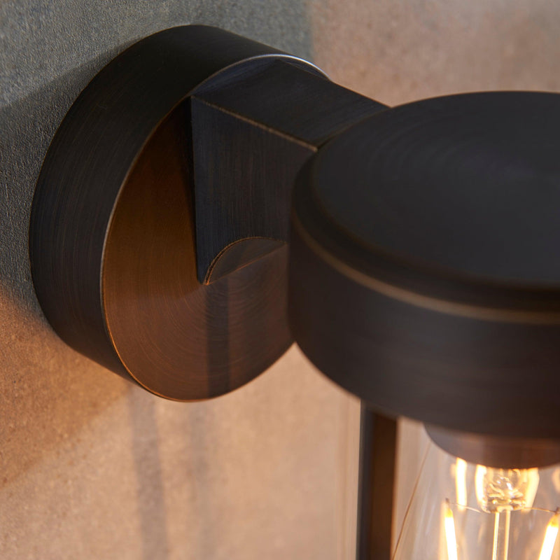 Newquay Bronze Outdoor Wall Light - Clear Glass Shade Bedroom Image