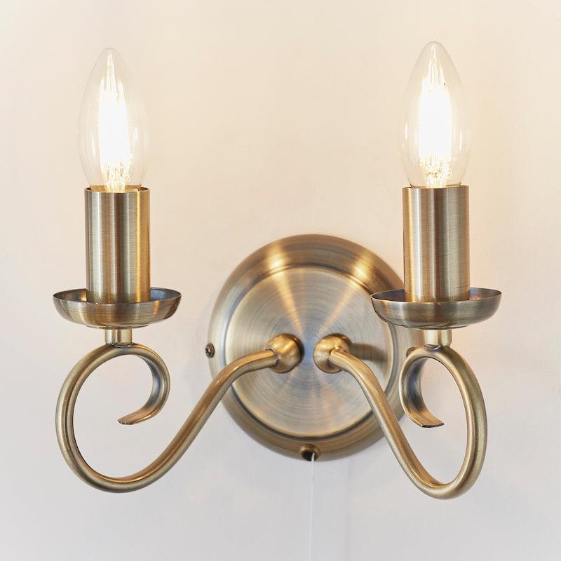 Traditional Wall Lights - Trafford Antique Brass Finish Twin Arm Wall Light 180-1AN turned on