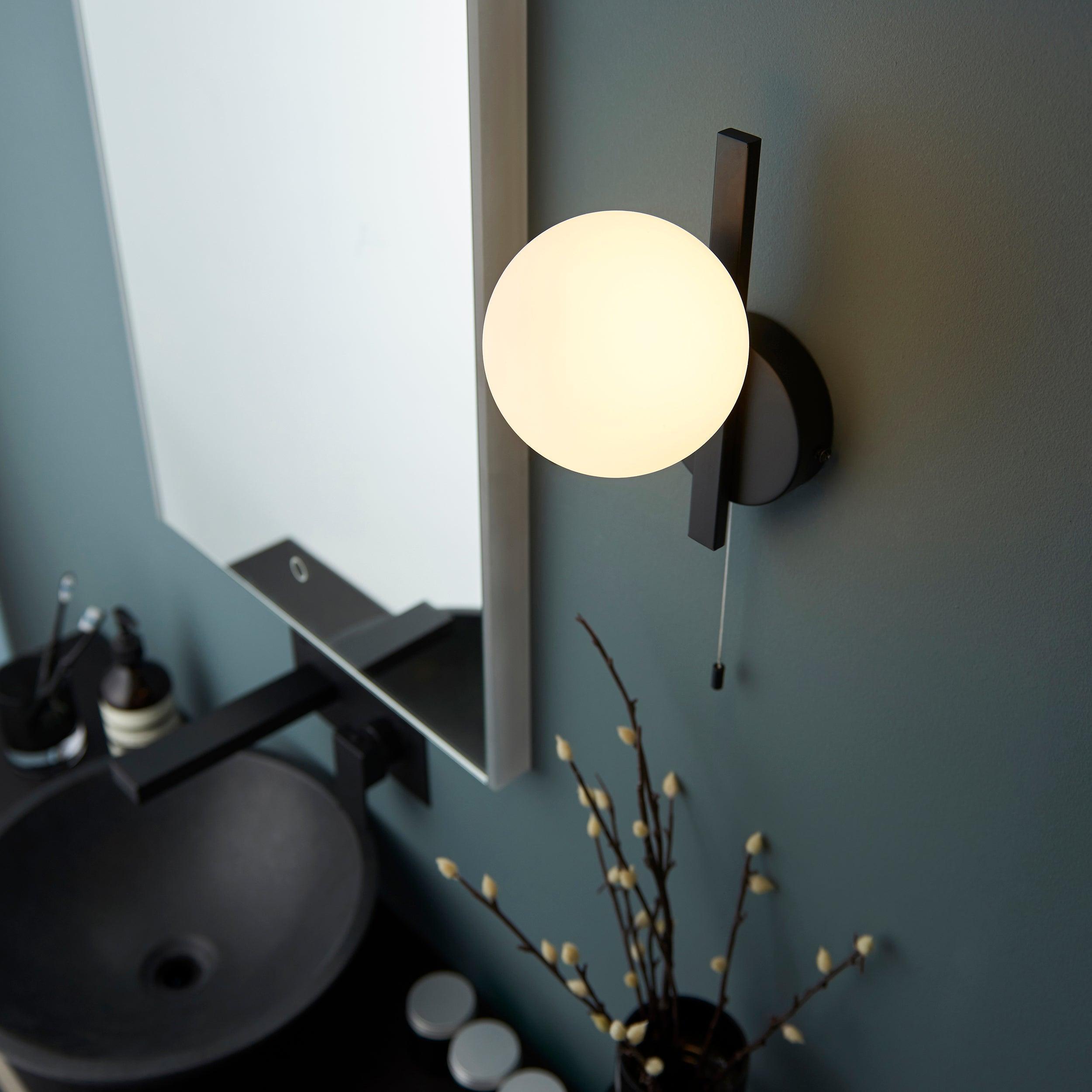 pendle black opal glass bathroom wall light pull cord Close Up Lit Image