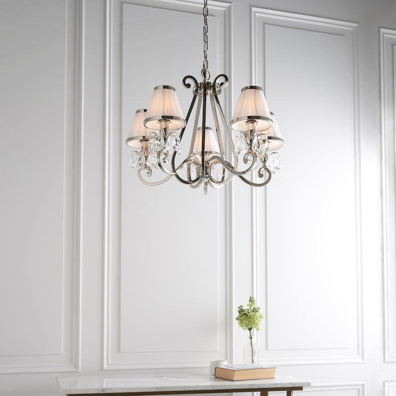 Oksana nickel chandelier 63515 white shades.  living room shot from below