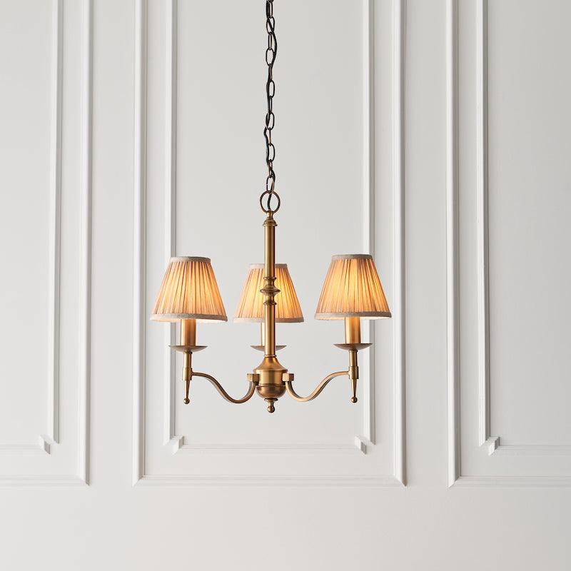 Traditional Ceiling Pendant Lights - Stanford 3 Light Antique Brass Chandelier With Beige Shades 63628 livign room shot