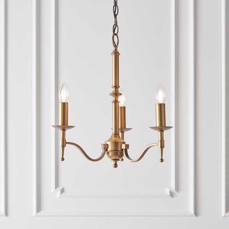 Traditional Ceiling Pendant Lights - Stanford 3 Light Antique Brass Chandelier With Beige Shades 63628 lit shot