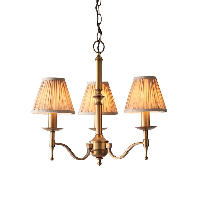 Traditional Ceiling Pendant Lights - Stanford 3 Light Antique Brass Chandelier With Beige Shades 63628 lit shot